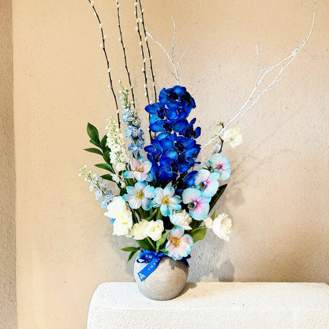 Frozen Orchids Arrangement with White and Blue Tulips in a Vase
