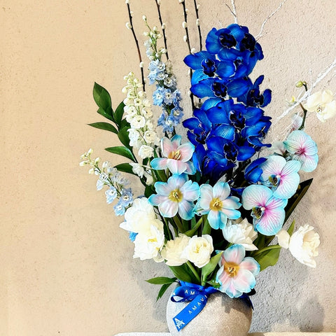 Frozen Orchids Arrangement with White and Blue Tulips in a Vase